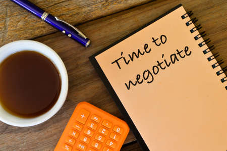 Top view of notebook written with text TIME TO NEGOTIATE.の写真素材