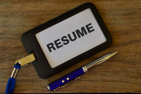 Pen and name tag written with text RESUME,