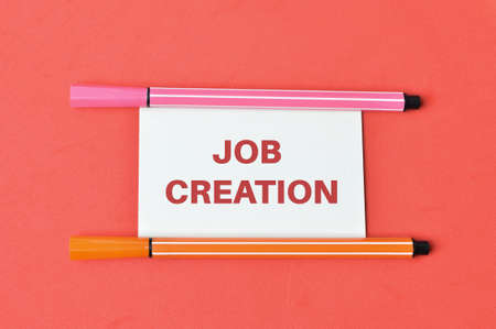 Pen colors and memo note written with JOB CREATION.