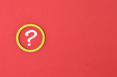 Question mark drawn on red background with copy spaceの写真素材
