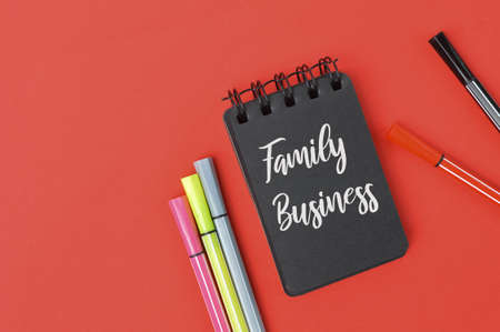 Pencil colors and notebook written with text FAMILY BUSINESS.の写真素材