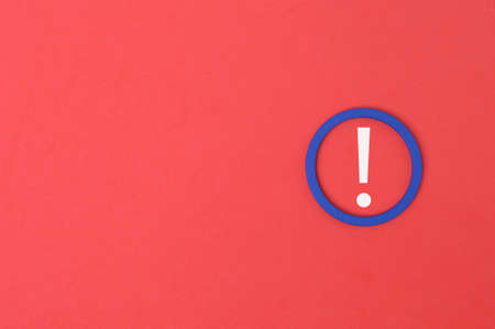 Exclamation mark drawn on red background with copy spaceの写真素材