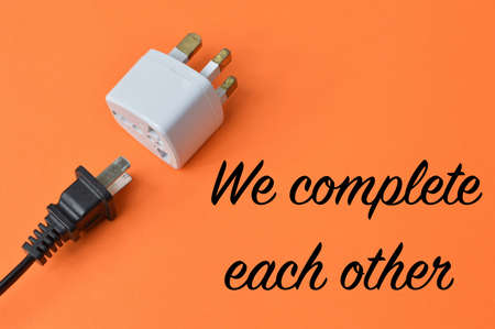 Plug and socket over orange background written with WE COMPLETE EACH OTHER.