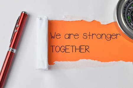 Torn paper written with text WE ARE STRONGER TOGETHER.の写真素材