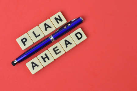 Pen and square letters with text PLAN AHEAD.