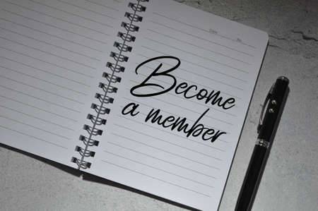 Pen and notebook written with BECOME A MEMBER.