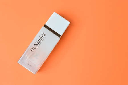Klang,Malaysia: March 5, 2021-Perfume bottle over orange background. De'Xandra Brand.のeditorial素材