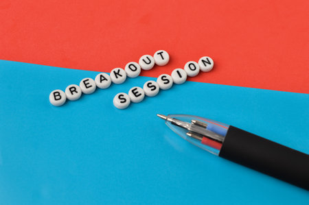 Top view of pen and alphabet beads with text BREAKOUT SESSION.の写真素材