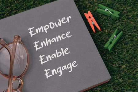Notebook written with text EMPOWER, ENHANCE, ENABLE and ENGAGE.の写真素材