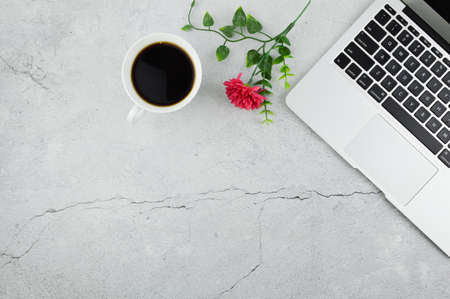 Top view of coffee, flower and laptop with copy space