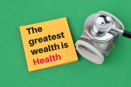 Memo note written with text THE GREATEST WEALTH IS HEALTHの写真素材