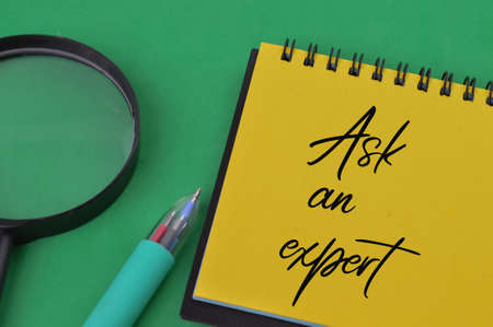 Notebook written with text ASK AN EXPERTの写真素材
