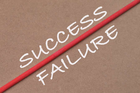 Brown background written with SUCCESS and FAILURE. Business and education concept.の写真素材
