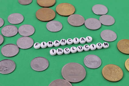 Coins and alphabet beads with text FINANCIAL INCLUSION.の写真素材