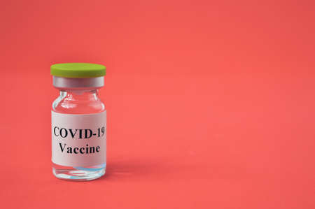 Covid-19 bottle vaccination over red background