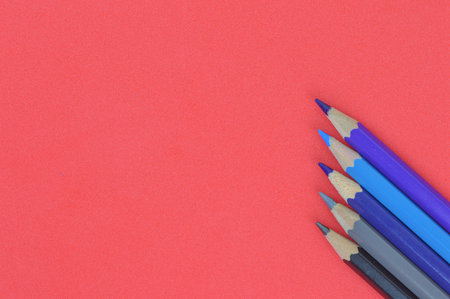 Pencil colors over red background with copy space.の写真素材