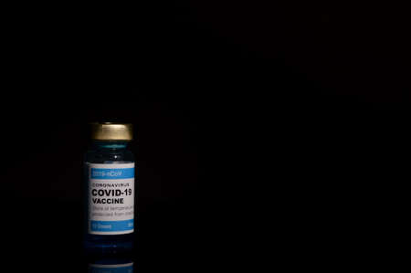 Coronavirus Covid-19 bottle vaccination over black background