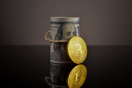 Golden bitcoin and money banknote on the tableの写真素材