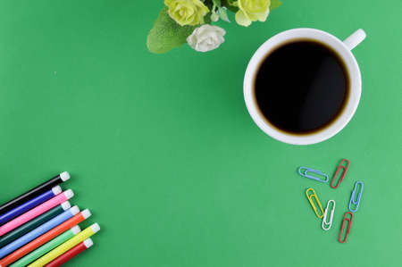 A cup of coffee, flower and stationery tools with copy spaceの写真素材