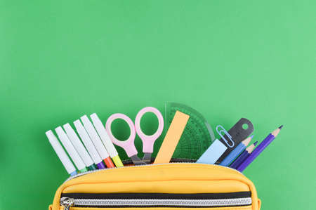 Top view of stationery tools over green background with copy space.の写真素材
