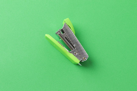 Top view of stapler over green backgroundの写真素材