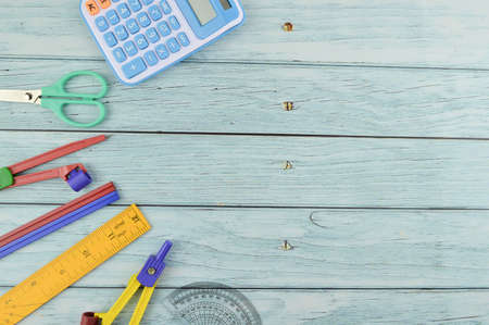Stationery tools over wooden background with copy space