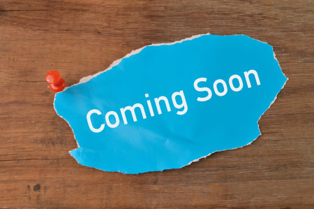 Torn paper written with COMING SOON.の写真素材