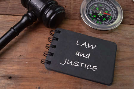Judge gavel, compass and notebook written with LAW AND JUSTICEの写真素材