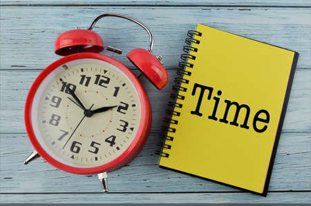 Alarm clock and notebook written with TIME
