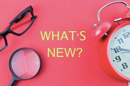 Top view of red background written with WHAT'S NEW?