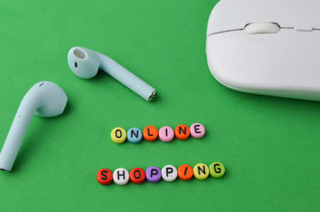 Computer mouse, earphones and alphabet beads with text ONLINE SHOPPINGの写真素材