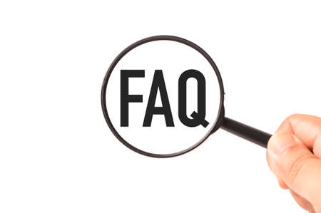 Magnifying glass written with FAQ stands for Frequently Asked Questionsの写真素材
