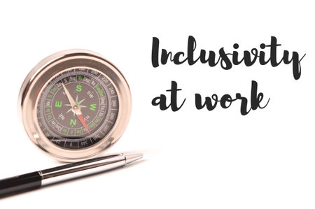 Pen and compass isolated on a white background written with INCLUSIVITY AT WORK. Business concept.の写真素材