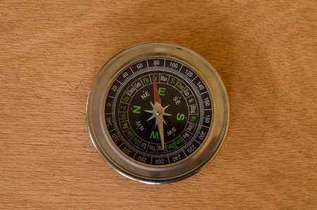 Top view of compass isolated on a wooden backgroundの写真素材