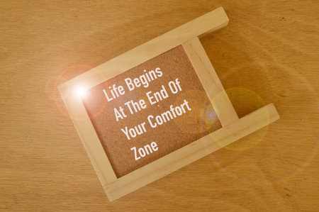 Motivational quote written with LIFE BEGINS AT THE END OF YOUR COMFORT ZONEの写真素材
