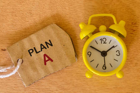 Speech bubble note written with PLAN A with clock. Business and education concept.の写真素材