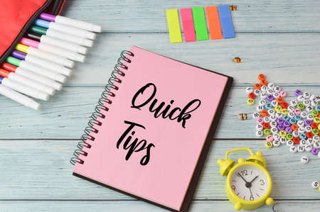 Stationery items and notebook written with QUICK TIPS.の写真素材