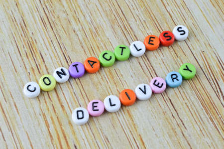 Colorful alphabet beads with text CONTACTLESS DELIVERYの写真素材
