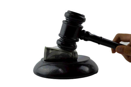 Judge gavel and money banknote isolated on a white background