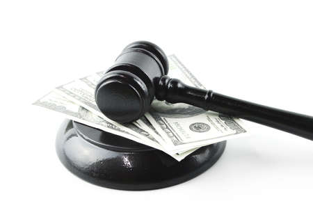 Judge gavel and money banknotes isolated on a white background