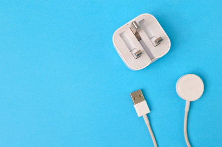Smartwatch magnetic charging cable isolated on a blue backgroundの写真素材