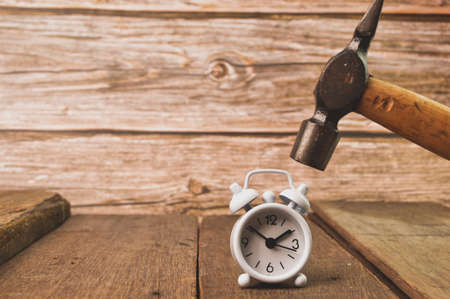 Smashing an alarm clock with a hammer