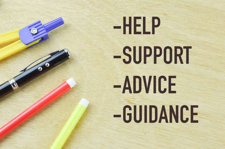 Wooden board written with HELP, SUPPORT, ADVICE and GUIDANCEの写真素材