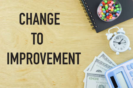Wooden board written with CHANGE TO IMPROVEMENT