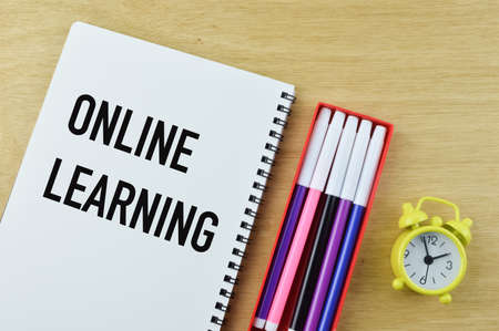 Top view of notebook written with ONLINE LEARNINGの写真素材