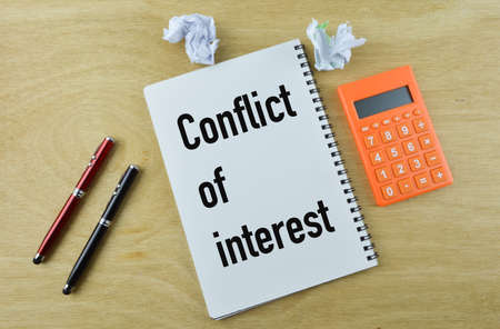Notebook written with text CONFLICT ON INTEREST. Top viewの写真素材