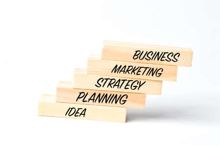 Wooden blocks written with BUSINESS, MARKETING, STRATEGY, PLANNING and IDEA.