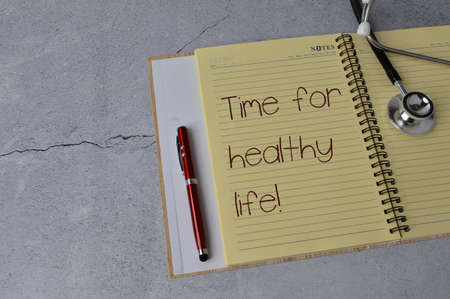 Notebook written with text TIME FOR HEALTHY LIFEの写真素材
