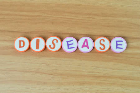Alphabet letters with text DISEASE. Top view.