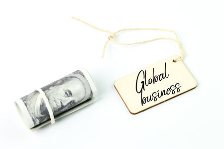 Money banknote and label tag written with GLOBAL BUSINESS.の写真素材